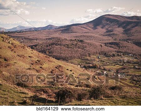 Stock Photo - Fields and mountains in rural landscape. Fotosearch