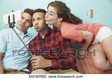 Friends making faces and taking selfie View Large Photo Image Stock Image - Friends making faces and taking selfie. Fotosearch