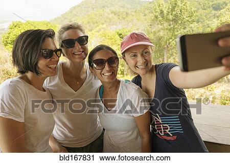 Stock Image - Friends taking selfie outdoors. Fotosearch