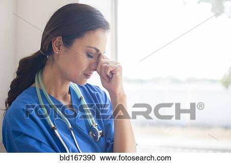Frustrated Mixed race nurse at window View Large Photo Image Stock Image - Frustrated Mixed race nurse at window. Fotosearch