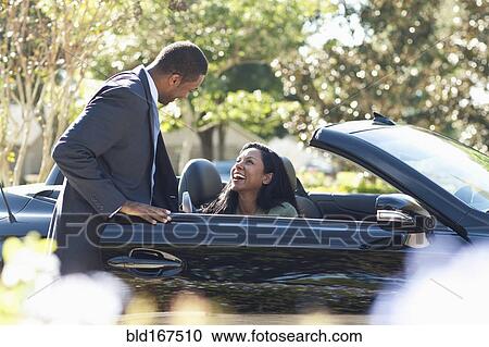 Gentleman opening door of convertible for woman View Large Photo Image Stock Image - Gentleman opening door of convertible for woman. Fotosearch