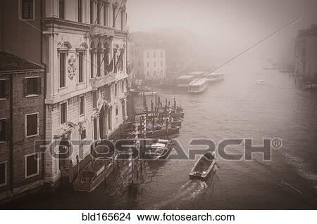 Picture - High angle view of boat in urban canal, Venice, Veneto, Italy. Fotosearch