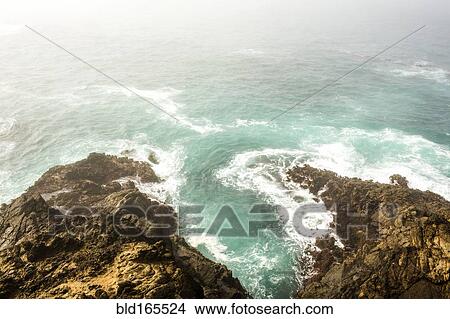 Picture - High angle view of ocean waves crashing on cliffs. Fotosearch