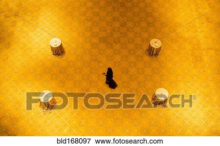 High angle view of woman walking on gold floor View Large Photo Image Stock Photo - High angle view of woman walking on gold floor. Fotosearch