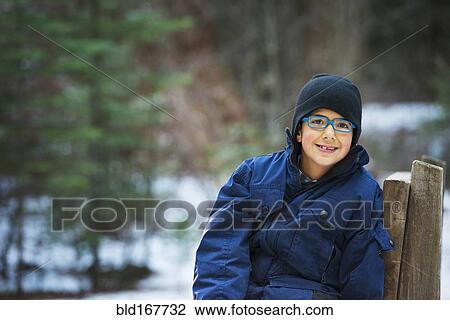 Hispanic boy sitting on chair in forest View Large Photo Image Stock Image - Hispanic boy sitting on chair in forest. Fotosearch
