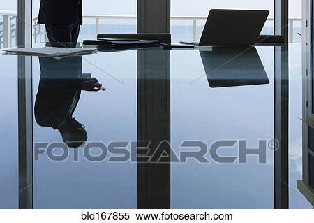 Hispanic businessman using cell phone in conference room View Large Photo Image Stock Photography - Hispanic businessman using cell phone in conference room. Fotosearch
