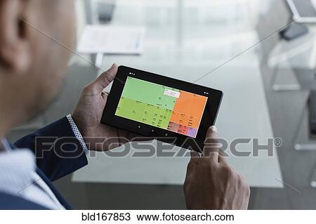 Hispanic businessman viewing graph on digital tablet View Large Photo Image Stock Image - Hispanic businessman viewing graph on digital tablet. Fotosearch