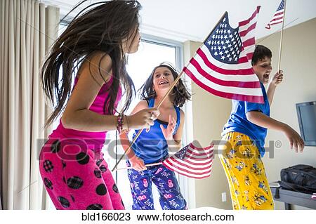 Hispanic children jumping with American flags View Large Photo Image Stock Image - Hispanic children jumping with American flags. Fotosearch