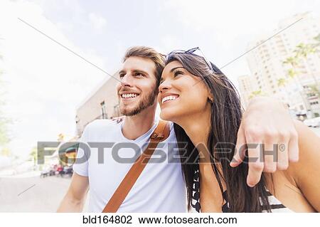 Hispanic couple hugging on sidewalk View Large Photo Image Stock Image - Hispanic couple hugging on sidewalk. Fotosearch