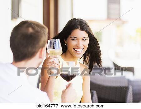 Stock Photo - Hispanic couple toasting with wine. Fotosearch