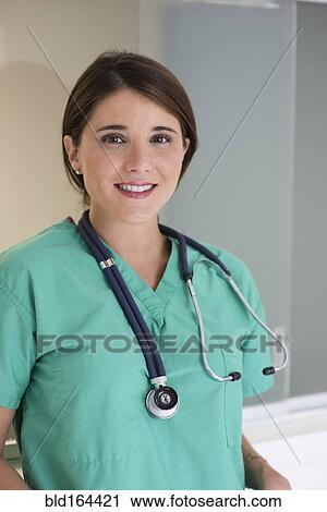 Stock Image - Hispanic doctor wearing stethoscope in hospital. Fotosearch