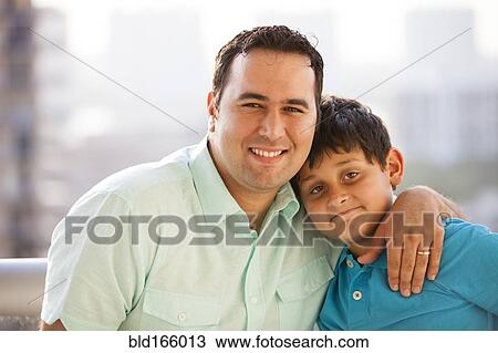 Hispanic father hugging son and smiling View Large Photo Image Stock Image - Hispanic father hugging son and smiling. Fotosearch