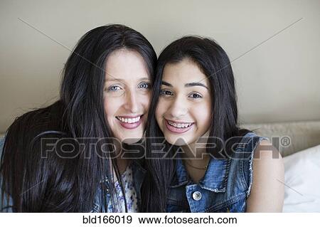 Hispanic mother and daughter smiling View Large Photo Image Stock Photo - Hispanic mother and daughter smiling. Fotosearch