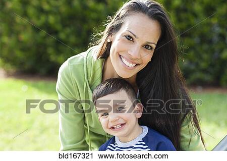Stock Image - Hispanic mother and son smiling outdoors. Fotosearch