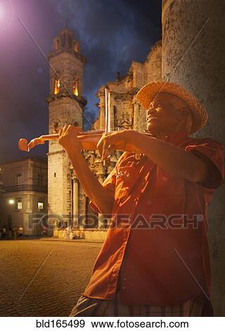 Stock Photo - Hispanic musician playing violin on Havana street, Havana, Cuba. Fotosearch