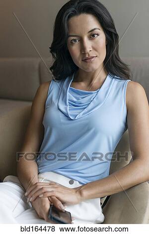Hispanic woman holding cell phone View Large Photo Image Stock Photo - Hispanic woman holding cell phone. Fotosearch