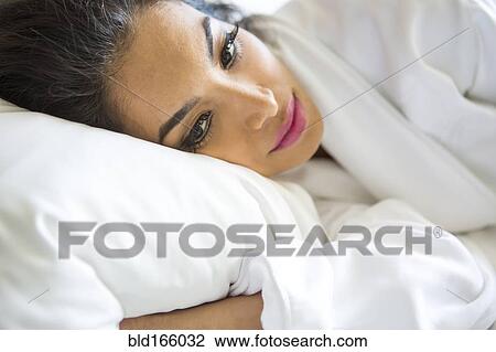 Hispanic woman laying in bed View Large Photo Image Stock Image - Hispanic woman laying in bed. Fotosearch
