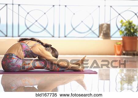 Hispanic woman practicing yoga on balcony View Large Photo Image Stock Photography - Hispanic woman practicing yoga on balcony. Fotosearch