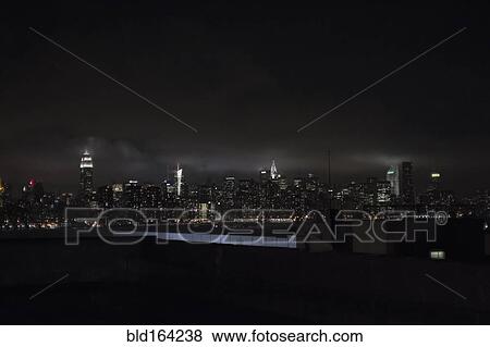 Illuminated New York City skyline at night, New York, United States View Large Photo Image Stock Photo - Illuminated New York City skyline at night, New York, United States. Fotosearch
