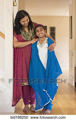 Stock Image - Indian mother and daughter wearing traditional dresses. Fotosearch