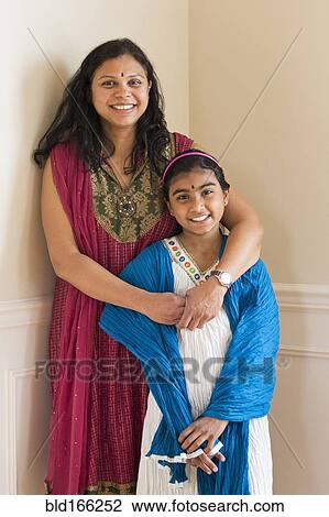 Stock Image - Indian mother and daughter wearing traditional dresses. Fotosearch