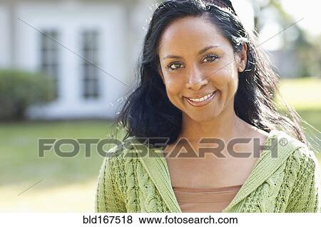 Indian woman smiling in backyard View Large Photo Image Stock Photo - Indian woman smiling in backyard. Fotosearch