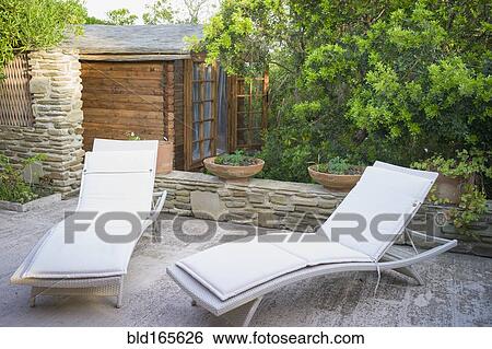 Stock Photograph - Lawn chairs on urban patio. Fotosearch
