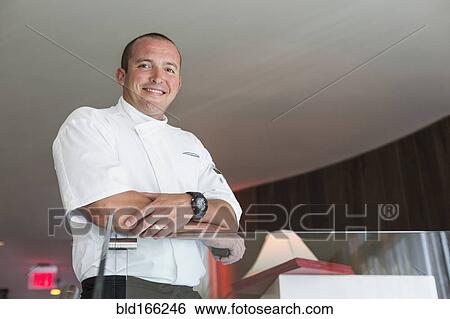 Low angle view of chef standing in dining room View Large Photo Image Stock Photograph - Low angle view of chef standing in dining room. Fotosearch