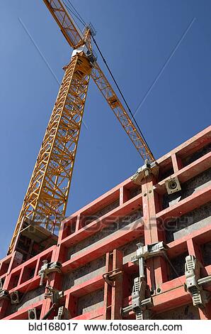 Low angle view of crane at construction site View Large Photo Image Stock Photo - Low angle view of crane at construction site. Fotosearch
