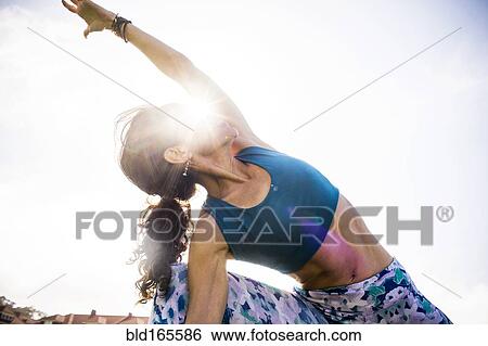 Low angle view of Hispanic woman practicing yoga outdoors View Large Photo Image Stock Photograph - Low angle view of Hispanic woman practicing yoga outdoors. Fotosearch