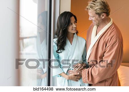 Man rubbing belly of pregnant wife in bedroom View Large Photo Image Stock Photo - Man rubbing belly of pregnant wife in bedroom. Fotosearch