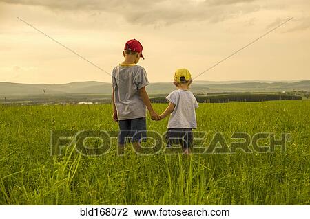 Mari brothers exploring in rural field View Large Photo Image Stock Image - Mari brothers exploring in rural field. Fotosearch