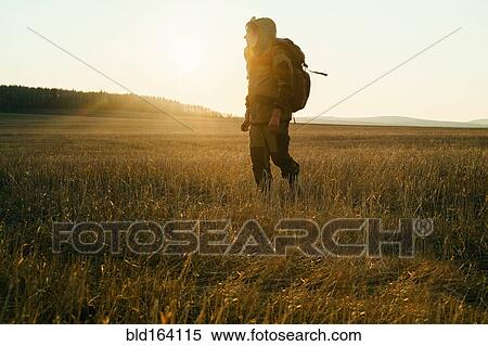 Mari man walking in rural field at sunrise View Large Photo Image Stock Photography - Mari man walking in rural field at sunrise. Fotosearch