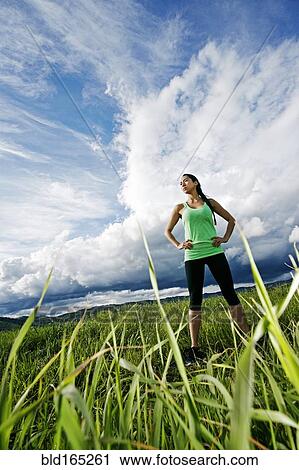 Mixed race athlete standing in rural field View Large Photo Image Stock Image - Mixed race athlete standing in rural field. Fotosearch