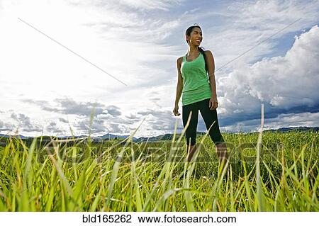 Mixed race athlete standing in rural field View Large Photo Image Stock Image - Mixed race athlete standing in rural field. Fotosearch