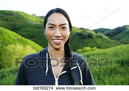 Picture - Mixed race athlete standing on rural hillside. Fotosearch