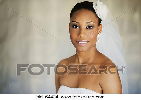 Mixed race bride wearing wedding gown and veil View Large Photo Image Picture - Mixed race bride wearing wedding gown and veil. Fotosearch