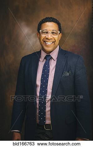 Stock Image - Mixed race businessman smiling. Fotosearch