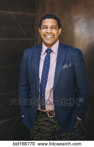 Stock Image - Mixed race businessman smiling. Fotosearch