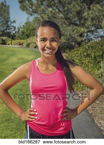 Stock Photo - Mixed race girl smiling in park. Fotosearch