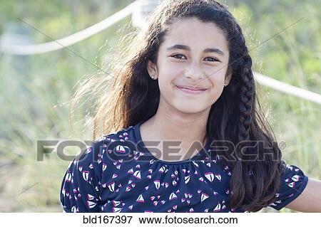 Stock Photo - Mixed race girl smiling outdoors. Fotosearch