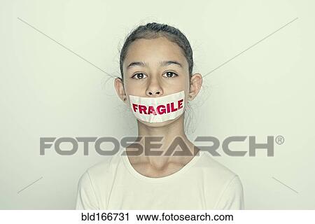 Mixed race girl wearing fragile sticker over mouth View Large Photo Image Stock Image - Mixed race girl wearing fragile sticker over mouth. Fotosearch