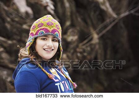 Mixed race girl wearing knit cap in forest View Large Photo Image Stock Image - Mixed race girl wearing knit cap in forest. Fotosearch
