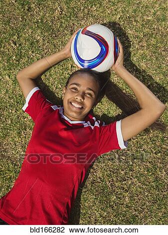 Mixed race soccer player laying on field View Large Photo Image Stock Image - Mixed race soccer player laying on field. Fotosearch
