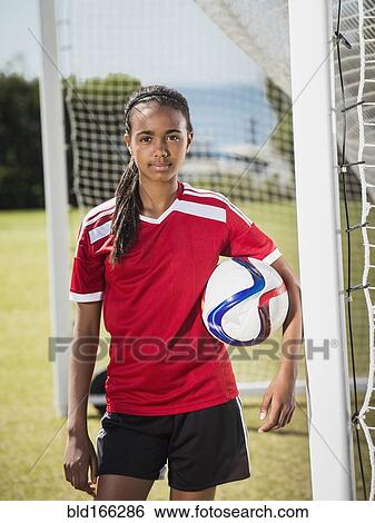 Stock Photograph - Mixed race soccer player standing in goal. Fotosearch