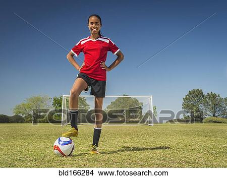 Mixed race soccer player standing on field View Large Photo Image Picture - Mixed race soccer player standing on field. Fotosearch