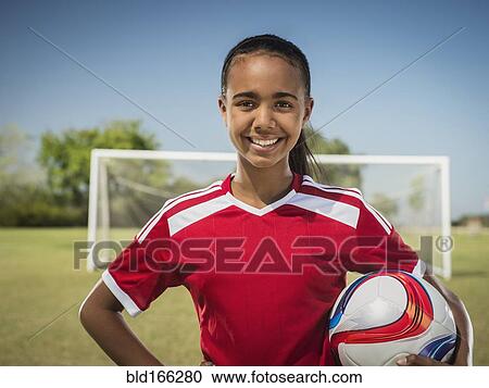 Mixed race soccer player standing on field View Large Photo Image Stock Image - Mixed race soccer player standing on field. Fotosearch