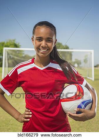 Stock Photo - Mixed race soccer player standing on field. Fotosearch