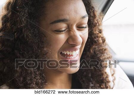 Mixed race teenage girl laughing in car back seat View Large Photo Image Stock Image - Mixed race teenage girl laughing in car back seat. Fotosearch