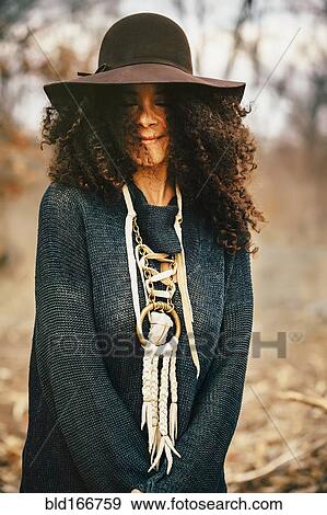Mixed race woman wearing stylish sweater and hat View Large Photo Image Stock Photo - Mixed race woman wearing stylish sweater and hat. Fotosearch